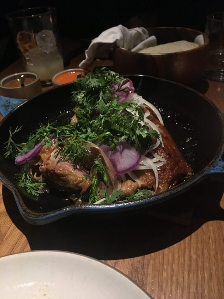 Platillo de carnitas de pato servido en Cosme, Nueva York. Fotografía de archivo ilustrativa de cocina mexicana contemporánea.